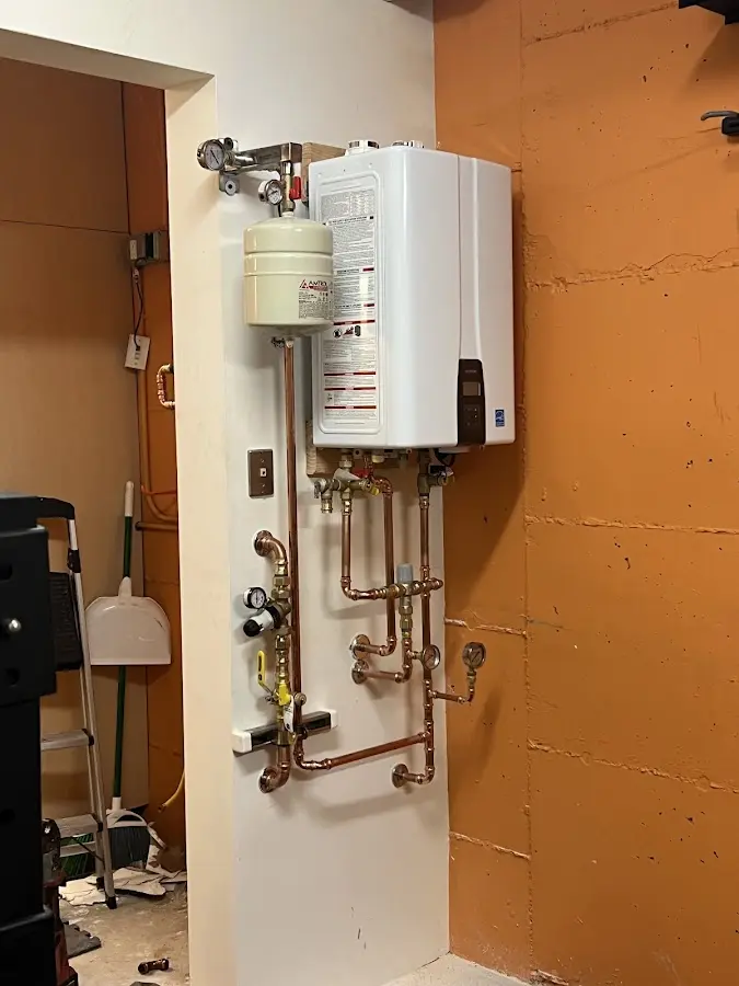 Plumbing technician inspecting water heater connections in Buffalo Grove